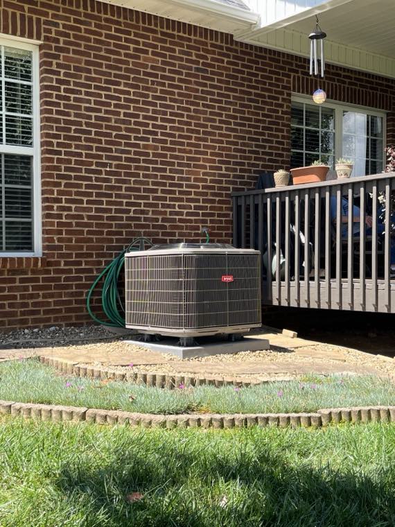 Clean outdoor condenser install at a brick home